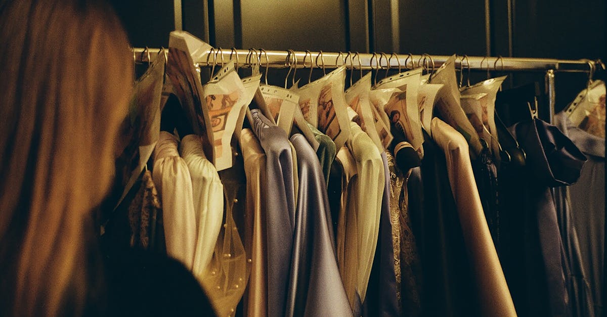 Stylish wardrobe with silk dresses on hangers, perfect for fashion enthusiasts.