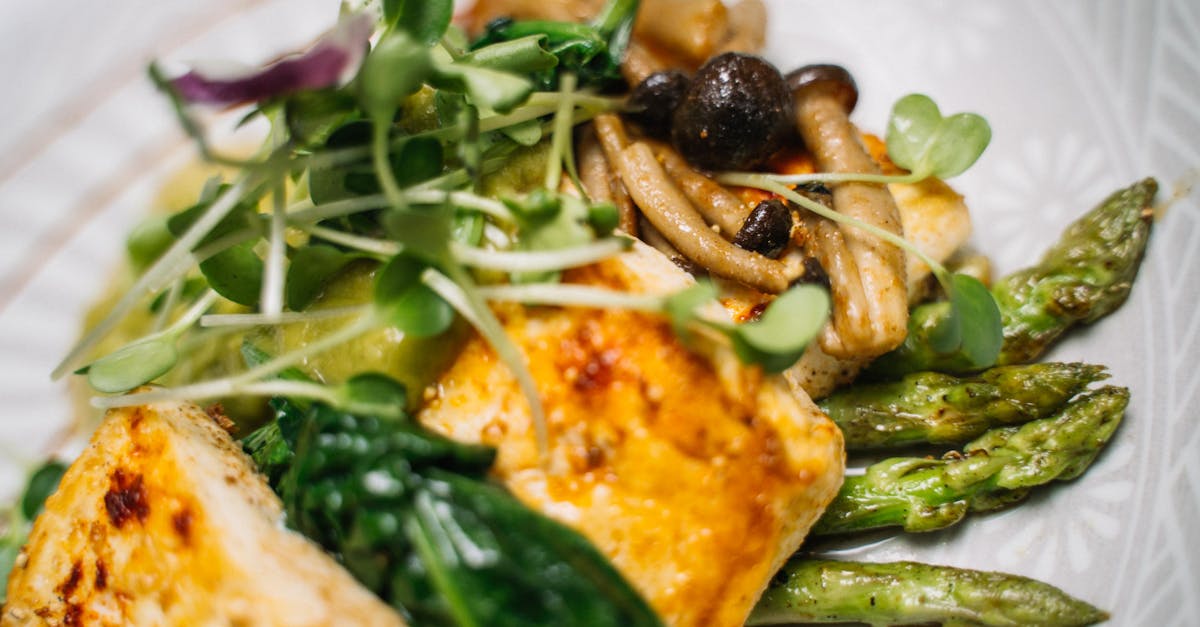 Delicious tofu meal served with crispy asparagus and sautéed mushrooms.