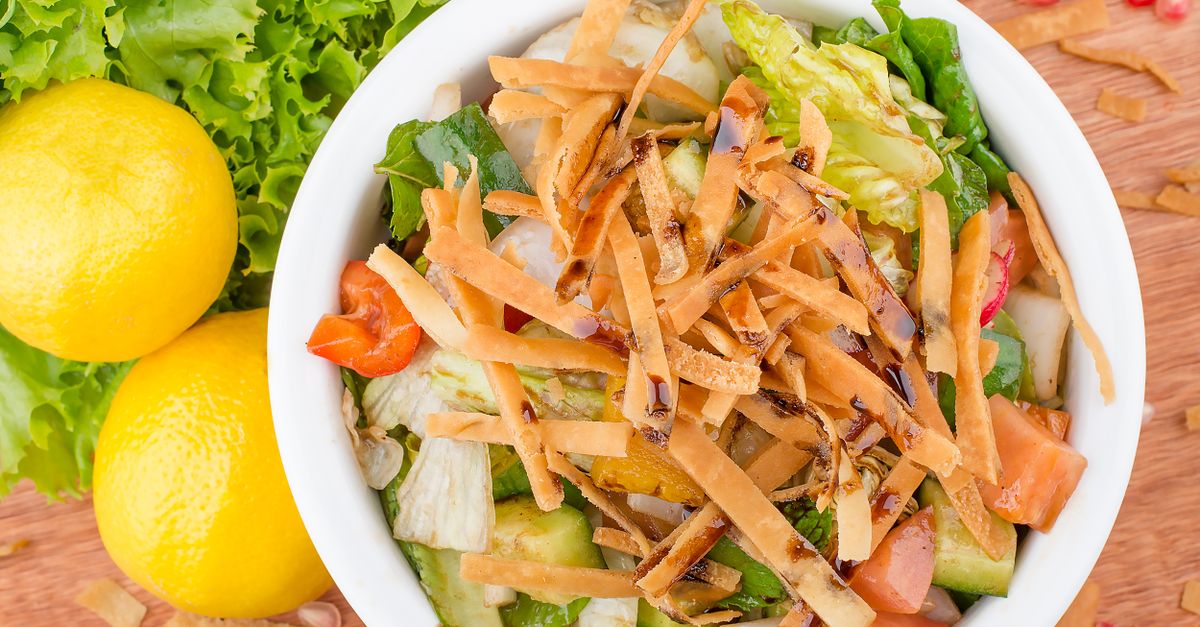 Vibrant bowl of mixed salad with fresh vegetables and crunchy toppings, perfect for a healthy meal.