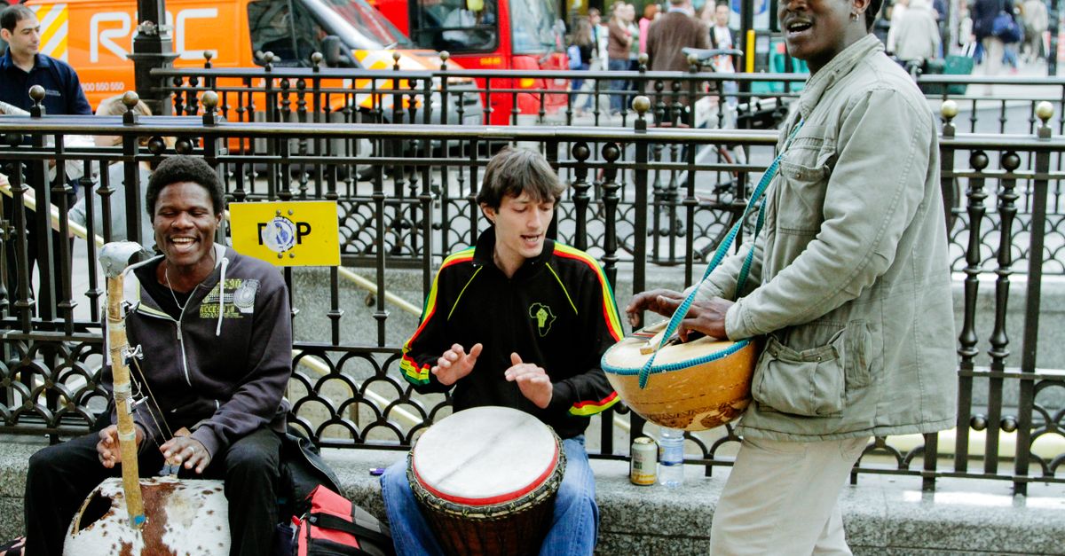 Street musicians playing lively tunes in London's bustling cityscape.