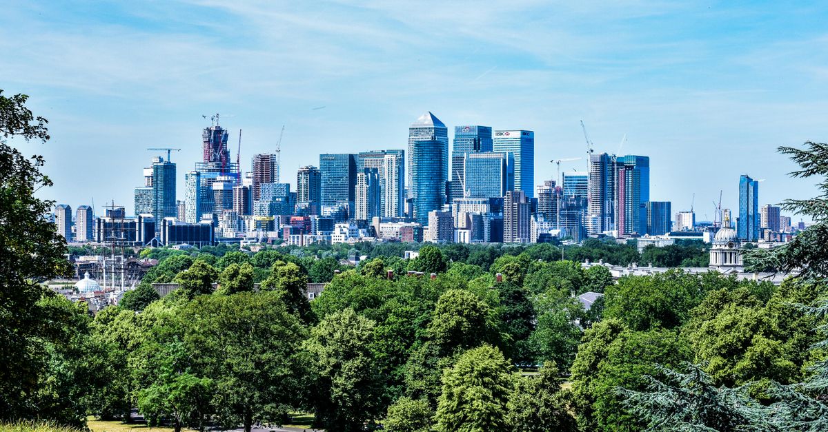 Stunning view of London skyline with greenery from Greenwich Park.