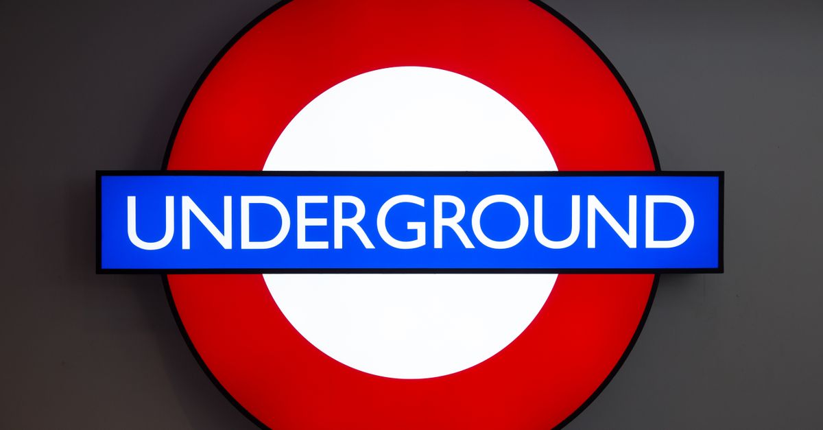 Close-up of the iconic London Underground roundel sign in bright colors.