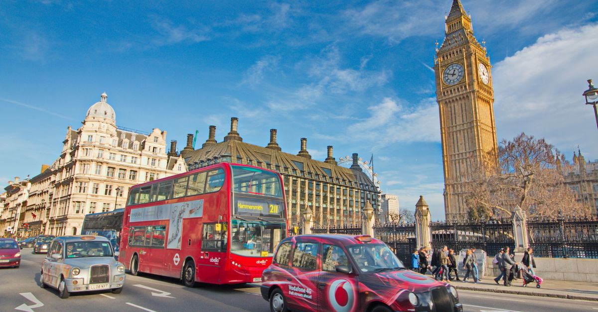 A vibrant scene of London with buses, taxis, and iconic Big Ben amidst urban life.