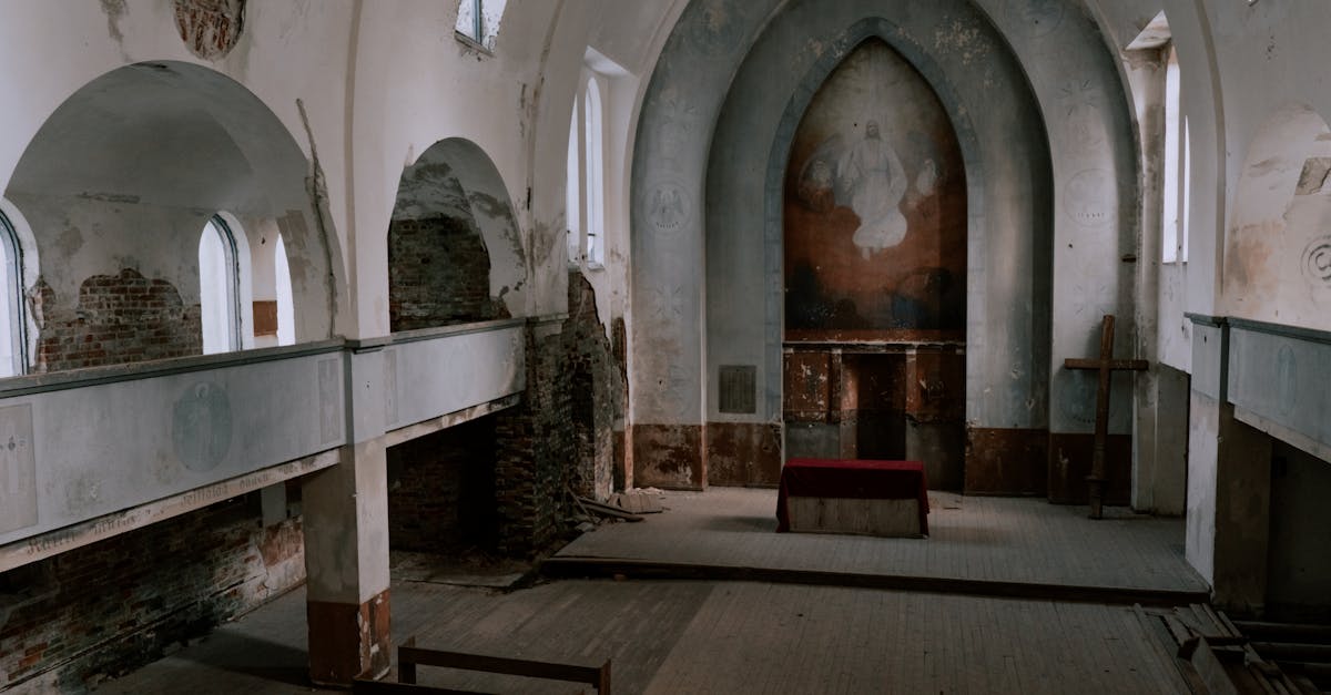 Exploring an abandoned church interior showcasing weathered architecture and altar.