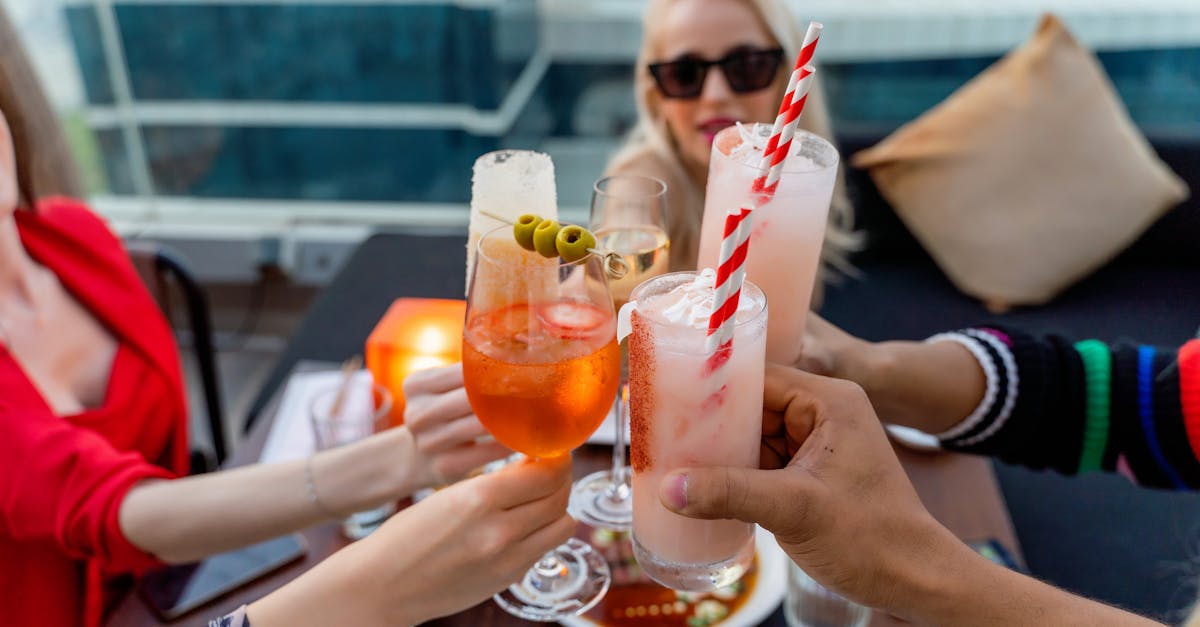 Friends raising glasses in celebration at a stylish rooftop bar in Dubai.