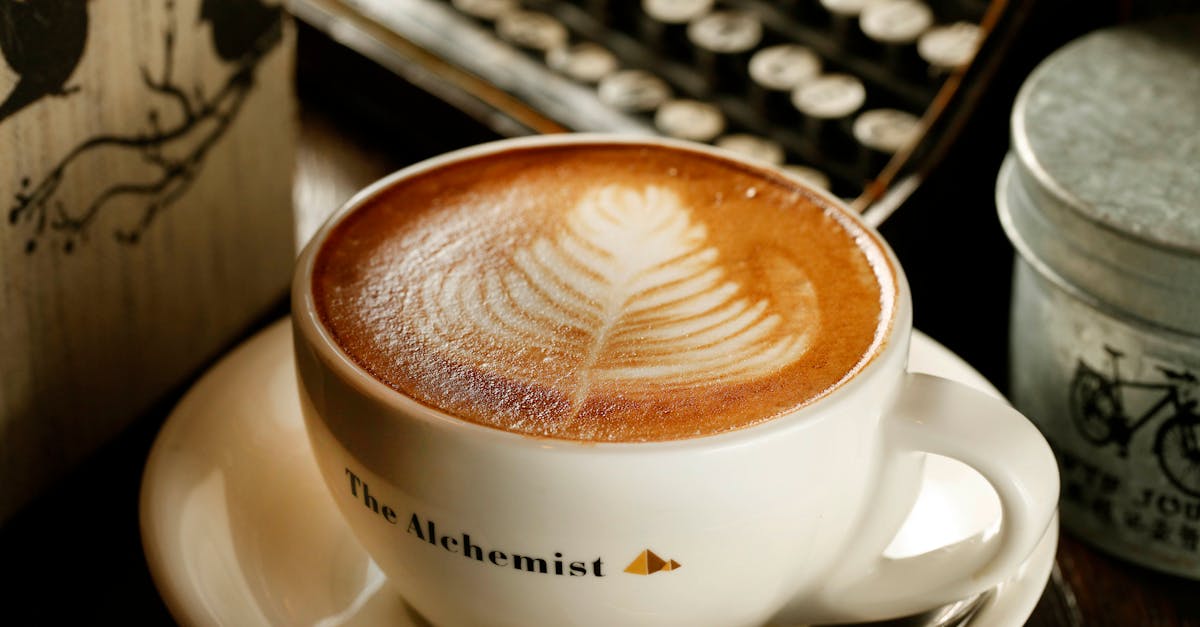 Close-up of a beautifully crafted latte art in a cafe setting, perfect for cozy atmosphere themes.