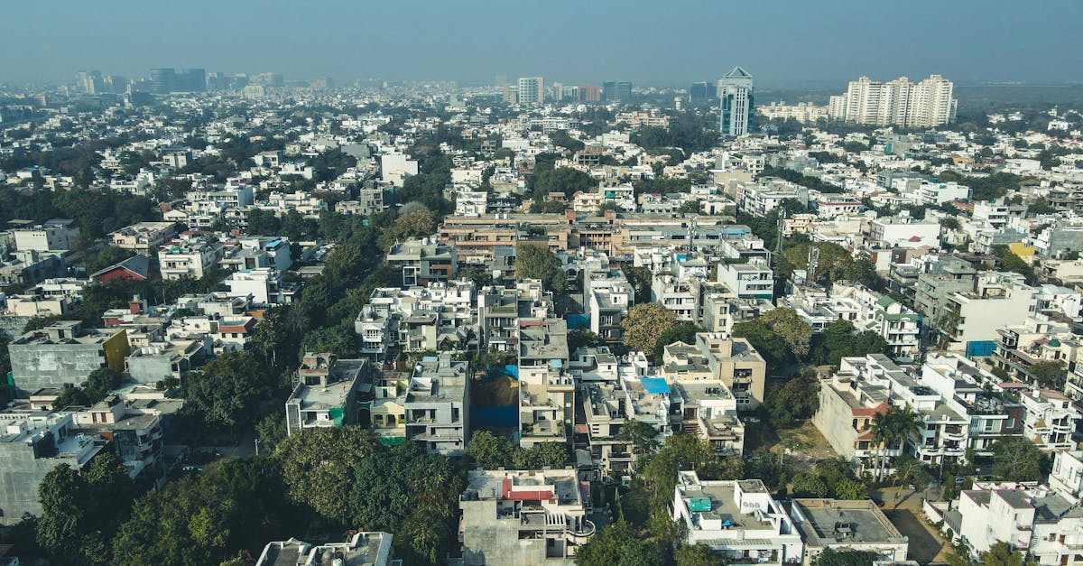 Aerial shot of Gurugram's urban landscape capturing dense residential buildings and city skyline.