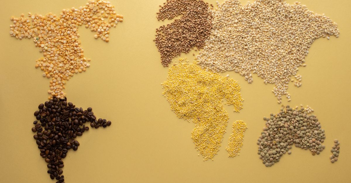 A world map creatively illustrated using diverse grains on a yellow background. Perfect for agricultural themes.