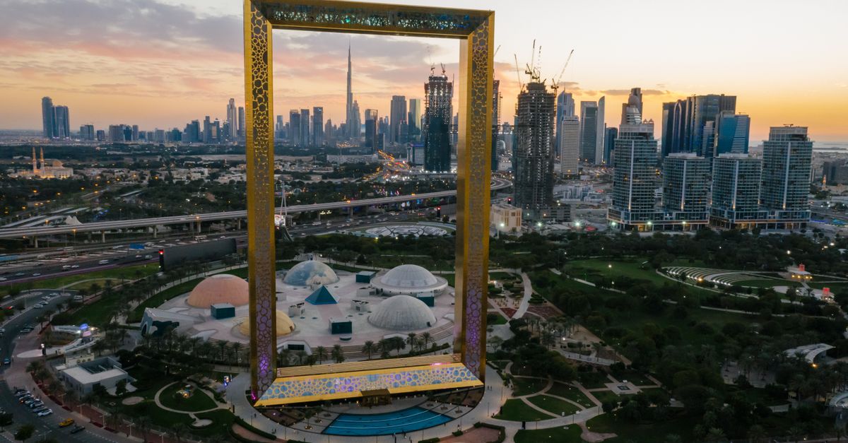 Aerial view of Dubai Frame with cityscape backdrop at sunset. Iconic landmark in UAE.
