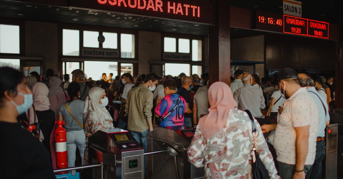People navigating through the crowded Üsküdar Ferry Terminal in Istanbul. Modern public transportation scene.