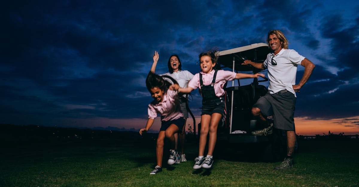A family enjoying a fun golf outing with kids playing and adults smiling at sunset.